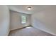 Bedroom with neutral carpet and walls, natural light from the window at 202 November St, Garner, NC 27529