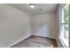 Bedroom with wood-look floors, closet, and window providing natural light at 202 November St, Garner, NC 27529