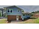 Back exterior of a two-story blue home with brick foundation and white trim at 202 November St, Garner, NC 27529