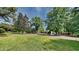 Expansive front yard with mature trees shading a home on a tree-lined street at 202 November St, Garner, NC 27529