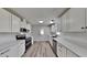 Modern kitchen with white cabinets, stainless steel appliances, and new countertops at 202 November St, Garner, NC 27529