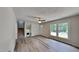 Bright living room with modern flooring, neutral paint, and staircase with a fireplace at 202 November St, Garner, NC 27529
