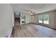 Bright living room with modern flooring, neutral paint, and staircase with a fireplace at 202 November St, Garner, NC 27529