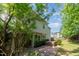 Lush backyard with mature trees and a relaxing hot tub area visible at 203 Downing Bluff Dr, Morrisville, NC 27560