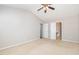 Spacious bedroom featuring neutral carpet, a ceiling fan, and a doorway to the bathroom at 203 Downing Bluff Dr, Morrisville, NC 27560