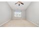 The spacious bedroom has neutral carpet, ceiling fan, and a large window at 203 Downing Bluff Dr, Morrisville, NC 27560