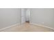 This bedroom has neutral carpet and paint with an open doorway revealing hardwood floors at 203 Downing Bluff Dr, Morrisville, NC 27560