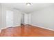 Bright bedroom featuring wood floors, neutral paint, and multiple closets at 203 Downing Bluff Dr, Morrisville, NC 27560