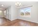 Bright dining room with hardwood floors and ample natural light from large window at 203 Downing Bluff Dr, Morrisville, NC 27560
