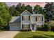 Charming two-story home with a well-manicured lawn and attached garage at 203 Downing Bluff Dr, Morrisville, NC 27560