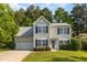 Charming two-story home with a well-manicured lawn and attached garage at 203 Downing Bluff Dr, Morrisville, NC 27560