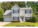 Traditional two-story home with black shutters and an attached garage at 203 Downing Bluff Dr, Morrisville, NC 27560