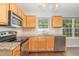 Bright kitchen features stainless appliances, granite countertops, and garden window at 203 Downing Bluff Dr, Morrisville, NC 27560