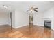 Open-concept living room with hardwood floors, fireplace, and natural light at 203 Downing Bluff Dr, Morrisville, NC 27560