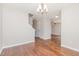 Spacious living room features beautiful wood floors and access to other rooms at 203 Downing Bluff Dr, Morrisville, NC 27560