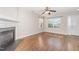 Bright living room featuring hardwood floors, fireplace, and two windows at 203 Downing Bluff Dr, Morrisville, NC 27560