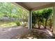 Covered brick patio surrounded by lush landscaping and a fenced yard at 203 Downing Bluff Dr, Morrisville, NC 27560
