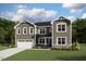 Charming two-story home featuring a two-car garage, well-manicured lawn, and inviting curb appeal at 203 Yellow River Way, Garner, NC 27529