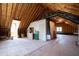 Large unfinished attic space with exposed beams and some storage at 205 Buncombe St, Raleigh, NC 27609