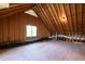 Unfinished attic space with exposed rafters, ductwork, and a window at 205 Buncombe St, Raleigh, NC 27609
