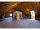 Spacious unfinished attic featuring exposed beams, plywood flooring and natural light at 205 Buncombe St, Raleigh, NC 27609