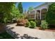 Expansive backyard featuring a covered porch area and lush landscaping, surrounded by mature trees at 205 Buncombe St, Raleigh, NC 27609