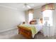 Cozy bedroom featuring warm colors, inviting windows, and ceiling fan at 205 Buncombe St, Raleigh, NC 27609