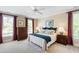 Comfortable bedroom with natural light, neutral walls, carpeting and featuring a plush bed and matching nightstands at 205 Buncombe St, Raleigh, NC 27609