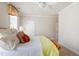 Well-lit bedroom featuring ceiling fan, hardwood bed frame and floral-themed window treatment at 205 Buncombe St, Raleigh, NC 27609
