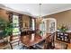 Formal dining room featuring a large wooden table, chandelier, and large windows at 205 Buncombe St, Raleigh, NC 27609