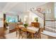 Inviting dining room with hardwood floors, statement light fixture, and access to a comfortable living area at 205 Buncombe St, Raleigh, NC 27609