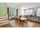 Open-concept dining space with hardwood floors, chandelier, and access to the kitchen, living area and stairs at 205 Buncombe St, Raleigh, NC 27609