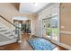 Bright foyer featuring hardwood floors, a staircase, and an inviting front door at 205 Buncombe St, Raleigh, NC 27609