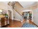 Grand foyer with hardwood floors, staircase, and arched doorways leading to other rooms at 205 Buncombe St, Raleigh, NC 27609