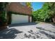 Spacious two-car garage with a clean, well-maintained concrete driveway and leafy green surroundings at 205 Buncombe St, Raleigh, NC 27609