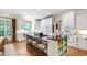 Modern kitchen boasts white cabinetry, a center island with seating, and granite countertops at 205 Buncombe St, Raleigh, NC 27609
