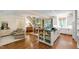 Open-concept kitchen and living area with hardwood floors and white cabinets at 205 Buncombe St, Raleigh, NC 27609