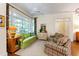 Cozy sunroom filled with natural light, features plush seating, ceiling fan, and views of the outdoors at 205 Buncombe St, Raleigh, NC 27609
