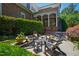 Inviting outdoor brick patio featuring Adirondack chairs and lush landscaping at 205 Buncombe St, Raleigh, NC 27609