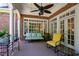 Covered back porch featuring brick flooring, white columns, and comfortable seating at 205 Buncombe St, Raleigh, NC 27609