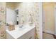Charming powder room featuring a vanity and decorative floral wallpaper at 205 Buncombe St, Raleigh, NC 27609