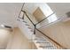 Bright staircase featuring wood treads, white risers and balusters, and light neutral walls at 205 Buncombe St, Raleigh, NC 27609