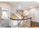 Upper level staircase with wood railing and open design, offering natural light and easy access to bedrooms at 205 Buncombe St, Raleigh, NC 27609