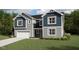 New construction two-story home with a two-car garage, neutral siding, and well-manicured front lawn at 211 Yellow River Way, Garner, NC 27529
