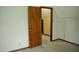 Carpeted bedroom with open door, leading to additional rooms and attic storage at 2315 George Anderson Dr, Hillsborough, NC 27278