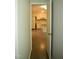 Hallway peek into kitchen area with white appliances and flooring at 2315 George Anderson Dr, Hillsborough, NC 27278