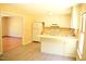 Bright kitchen features white cabinets, modern vinyl flooring, and a view of the adjacent room at 2315 George Anderson Dr, Hillsborough, NC 27278