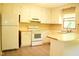 Bright kitchen with white cabinets, modern vinyl flooring, laminate countertop, and white appliances at 2315 George Anderson Dr, Hillsborough, NC 27278