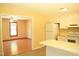 Bright kitchen with white cabinets, modern vinyl flooring, and an adjacent living room at 2315 George Anderson Dr, Hillsborough, NC 27278