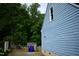 Side view of home with light-blue siding and garbage cans to the left at 2315 George Anderson Dr, Hillsborough, NC 27278